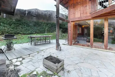 a patio with a table and a picnic table at Chalet of the 5 Chardons ski-in ski-out in Les Houches