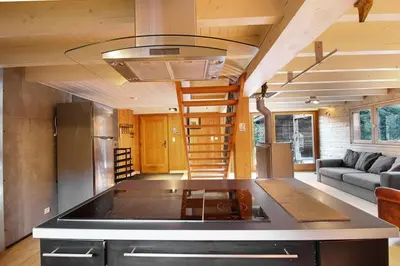 a kitchen and living room with a staircase in a tiny house at Chalet of the 5 Chardons ski-in ski-out in Les Houches
