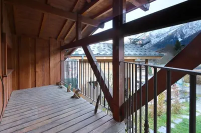 a balcony of a cabin with a view of a mountain at Chalet of the 5 Chardons ski-in ski-out in Les Houches