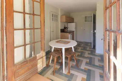 a kitchen with a white table and chairs in a room at Le Petit Eloi in Saint-Gervais-les-Bains