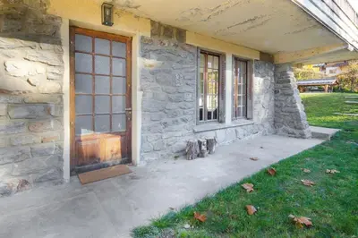 a stone house with a front door and windows at Le Petit Eloi in Saint-Gervais-les-Bains
