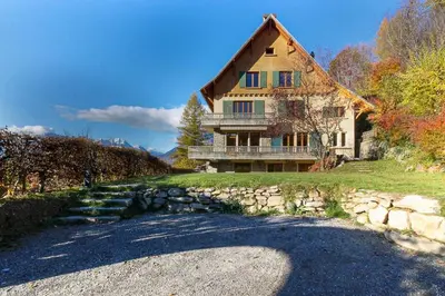 a large house with a stone path in front of it at Le Petit Eloi in Saint-Gervais-les-Bains
