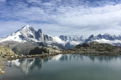 a view of a mountain range with a body of water at Majestic Broadway - 4 star apartment with spectacular views in Chamonix-Mont-Blanc