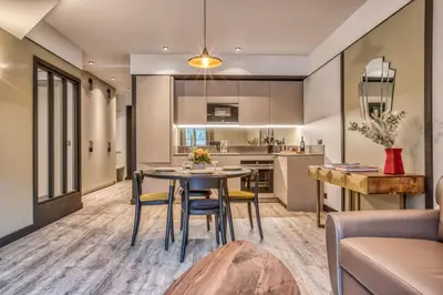 a kitchen and living room with a table and chairs at Majestic Broadway - 4 star apartment with spectacular views in Chamonix-Mont-Blanc
