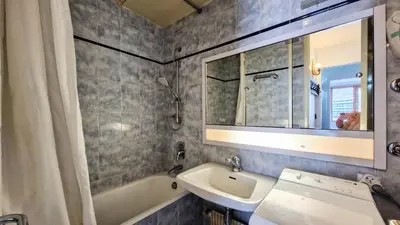 a bathroom with a sink and a tub and a mirror at Résidence Betelgeuse - Appartement confortable · Proche des pistes et des commerces · Balcon MAE-7376 in Flaine