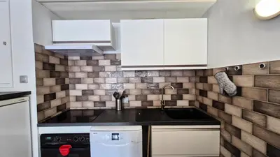 a kitchen with white cabinets and a sink at Résidence Betelgeuse - Appartement confortable · Proche des pistes et des commerces · Balcon MAE-7376 in Flaine
