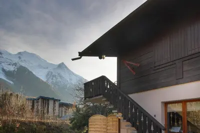 a house with a staircase with a view of a mountain at Les Fleurs de Cham - Jardin vues - Rénové in Chamonix-Mont-Blanc