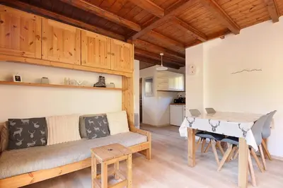 a living room with a couch and a table at Les Fleurs de Cham - Jardin vues - Rénové in Chamonix-Mont-Blanc