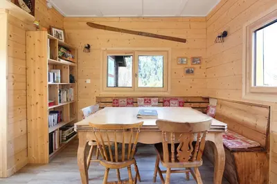 a dining room with a wooden table and chairs at Le Petite Chalet Tourmente in Chamonix-Mont-Blanc