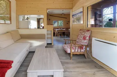 a living room with a couch and a table at Le Petite Chalet Tourmente in Chamonix-Mont-Blanc