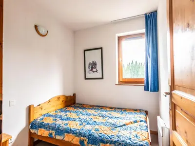a bedroom with a bed and a window at Vacancéole - Résidence Grand Morillon in Morillon