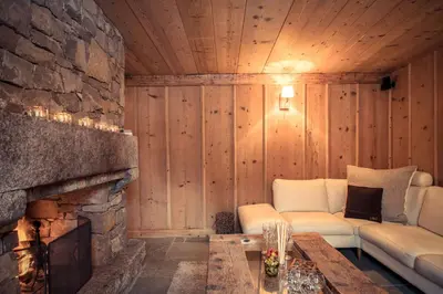 a living room with a couch and a fireplace at Paccard Locations Chamonix in Chamonix-Mont-Blanc