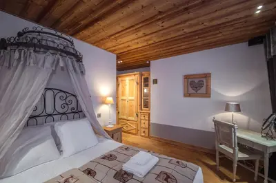 a bedroom with a bed and a desk in it at Paccard Locations Chamonix in Chamonix-Mont-Blanc