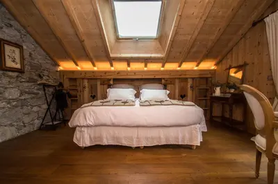 a bedroom with a bed in a room with a window at Paccard Locations Chamonix in Chamonix-Mont-Blanc