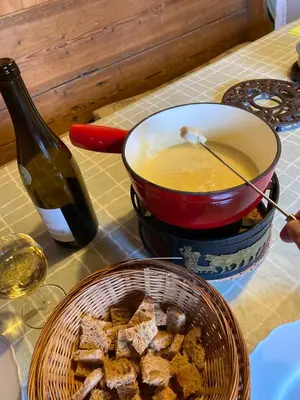 a pot of soup next to a bowl of food at Chalet Keller in Les Contamines-Montjoie