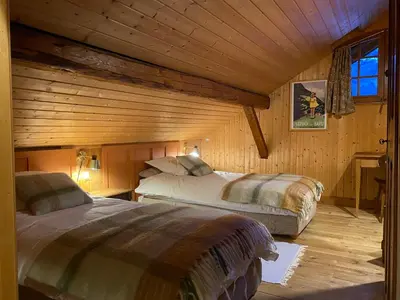 a bedroom with two beds in a log cabin at Chalet Keller in Les Contamines-Montjoie