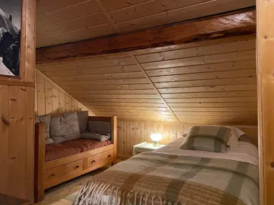 a bedroom with a bed in a log cabin at Chalet Keller in Les Contamines-Montjoie