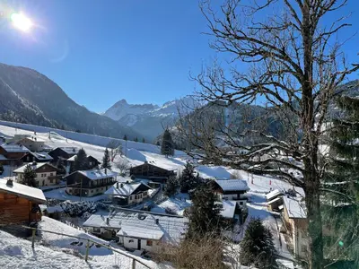 a village covered in snow with mountains in the background at Chalet Keller in Les Contamines-Montjoie