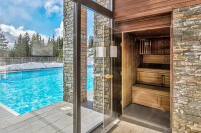 a bathroom with a shower and a swimming pool at Appartement Premium à Flaine, altitude 1740 m, 8 à 10 personnes, au pied des pistes, piscine, jacuzzi, sauna, hammam et salle de sport in Flaine