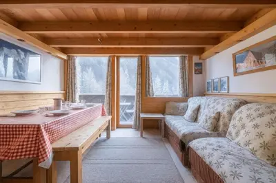 a living room with a couch and a table at Bel Apt Near The Slopes Argentiere in Chamonix-Mont-Blanc