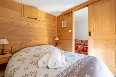 a bedroom with a bed with towels on it at Bel Apt Near The Slopes Argentiere in Chamonix-Mont-Blanc