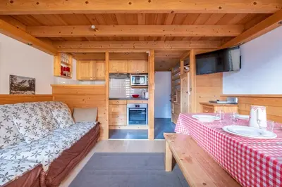a living room with a couch and a table in a cabin at Bel Apt Near The Slopes Argentiere in Chamonix-Mont-Blanc