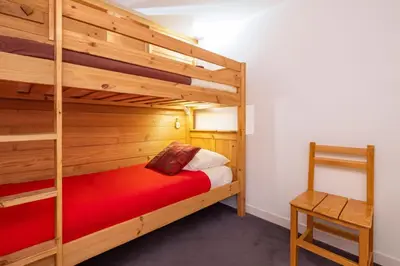 a bedroom with a bunk bed and a ladder at Bel Apt Near The Slopes Argentiere in Chamonix-Mont-Blanc