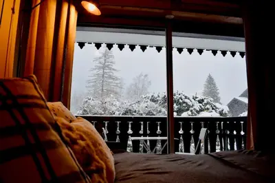 a bedroom window with a view of a snow covered yard at Studio Le 4122 - Chamonix centre Clos du Savoy in Chamonix-Mont-Blanc