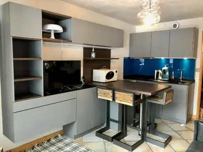 a kitchen with a wooden table in a room at Studio Le 4122 - Chamonix centre Clos du Savoy in Chamonix-Mont-Blanc