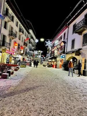 a group of people walking down a street at night at Studio Le 4122 - Chamonix centre Clos du Savoy in Chamonix-Mont-Blanc