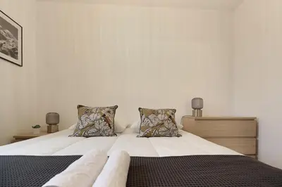 a bedroom with a bed with white sheets and pillows at Appartement L'Armancette - Proche centre et Bettex in Saint-Gervais-les-Bains