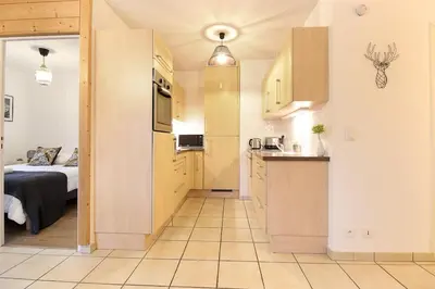 a room with a kitchen and a bedroom with a bed at Appartement L'Armancette - Proche centre et Bettex in Saint-Gervais-les-Bains