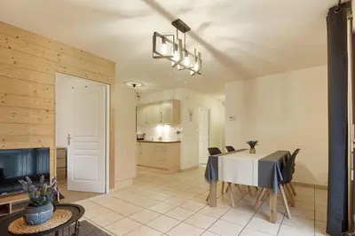 a kitchen and dining room with a table and chairs at Appartement L'Armancette - Proche centre et Bettex in Saint-Gervais-les-Bains