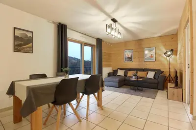 a living room with a table and chairs and a couch at Appartement L'Armancette - Proche centre et Bettex in Saint-Gervais-les-Bains