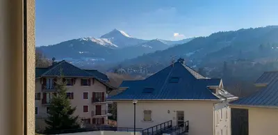 a view of a building with a mountain in the background at Appartement L'Armancette - Proche centre et Bettex in Saint-Gervais-les-Bains