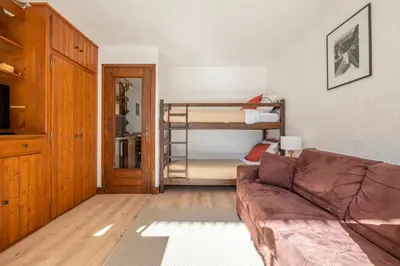 a living room with a couch and a bunk bed at Nice Studio With Balcony In Chamonix in Chamonix-Mont-Blanc