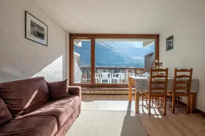 a living room with a couch and a table and chairs at Nice Studio With Balcony In Chamonix in Chamonix-Mont-Blanc