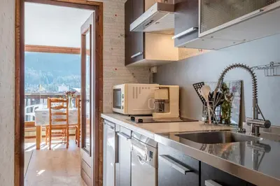 a kitchen with a sink and a microwave at Nice Studio With Balcony In Chamonix in Chamonix-Mont-Blanc