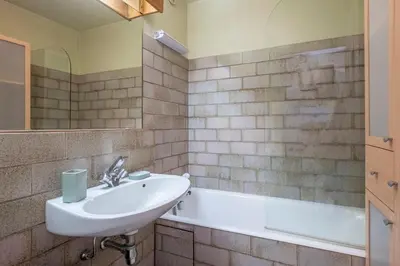 a bathroom with a sink and a bath tub at Nice Studio With Balcony In Chamonix in Chamonix-Mont-Blanc