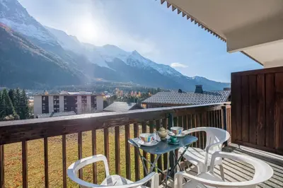 a table and chairs on a balcony with mountains at Nice Studio With Balcony In Chamonix in Chamonix-Mont-Blanc
