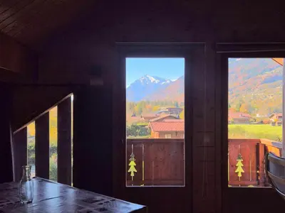 a room with two windows with a view of a mountain at Confortable T2 proche télécabine Grand Massif - FR-1-624-41 in Samoëns