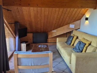 a living room with a couch and a table at Confortable T2 proche télécabine Grand Massif - FR-1-624-41 in Samoëns