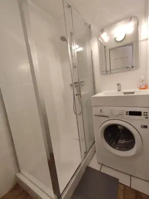 a bathroom with a washing machine and a washer at Samoëns - Studio Les Espaces in Samoëns