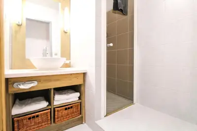 a bathroom with a sink and a shower at Newly redecorated 2-bed ski-in ski-out family apartment in Flaine