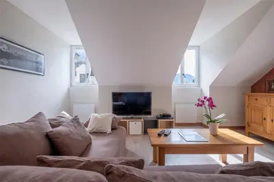 a living room with a couch and a coffee table at L'Appart 52, magnifique duplex en plein coeur de Chamonix-Mont-Blanc in Chamonix-Mont-Blanc