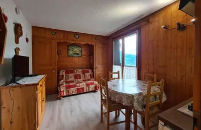 a dining room with a table and a bedroom at Alpenrose in Saint-Gervais-les-Bains