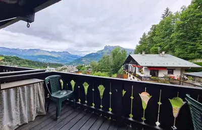 a balcony with a chair and a view of mountains at Alpenrose in Saint-Gervais-les-Bains