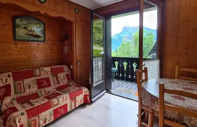 a room with a bed and a table and a window at Alpenrose in Saint-Gervais-les-Bains
