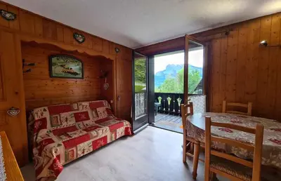 a bedroom with a bed and a large window at Alpenrose in Saint-Gervais-les-Bains