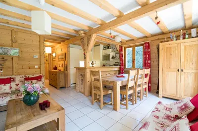 a kitchen and dining room with a table and chairs at Comme un chalet, appartement à la montagne in Saint-Gervais-les-Bains